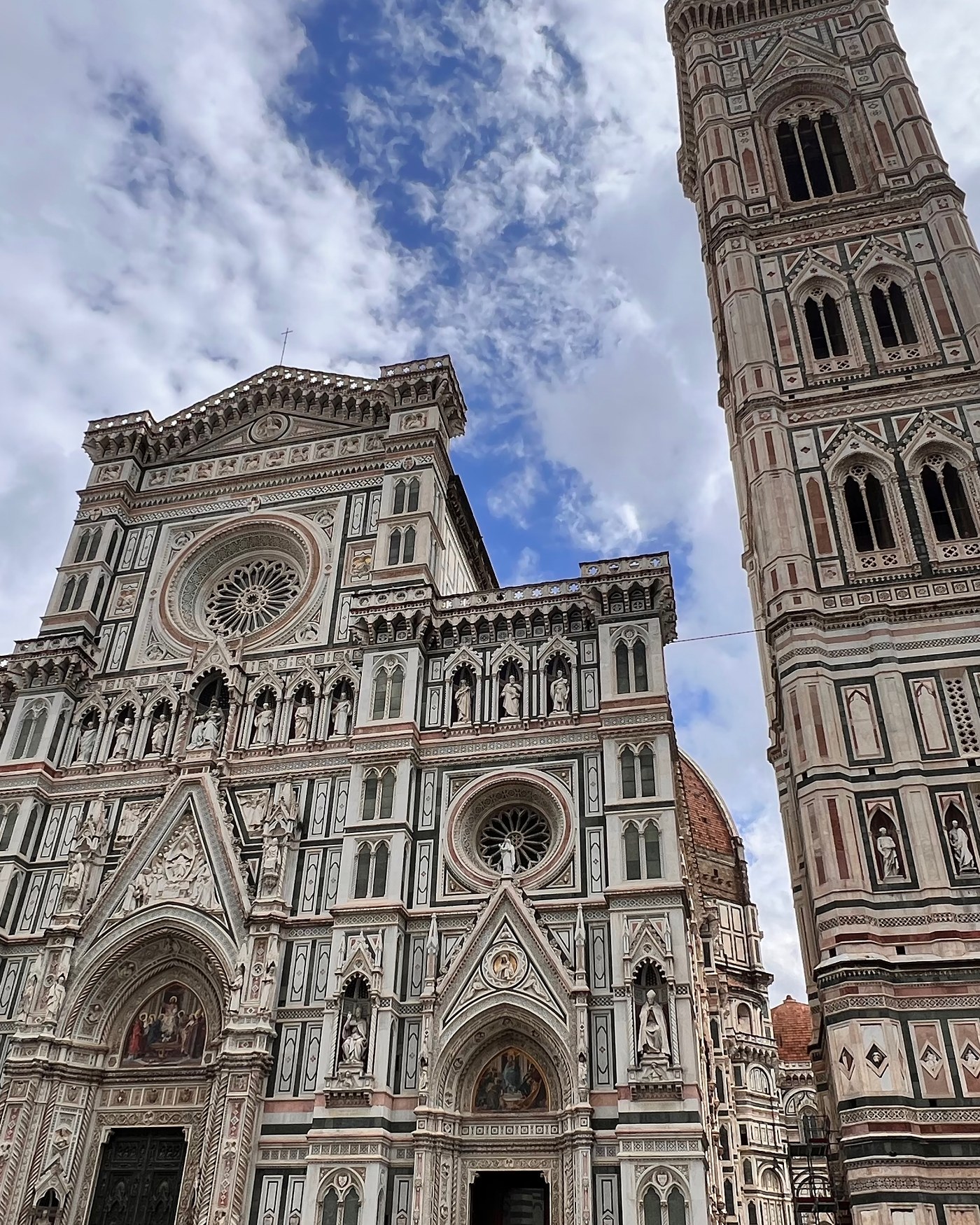 The facade of Florence Cathedral and Giotto's campanile against a blue sky