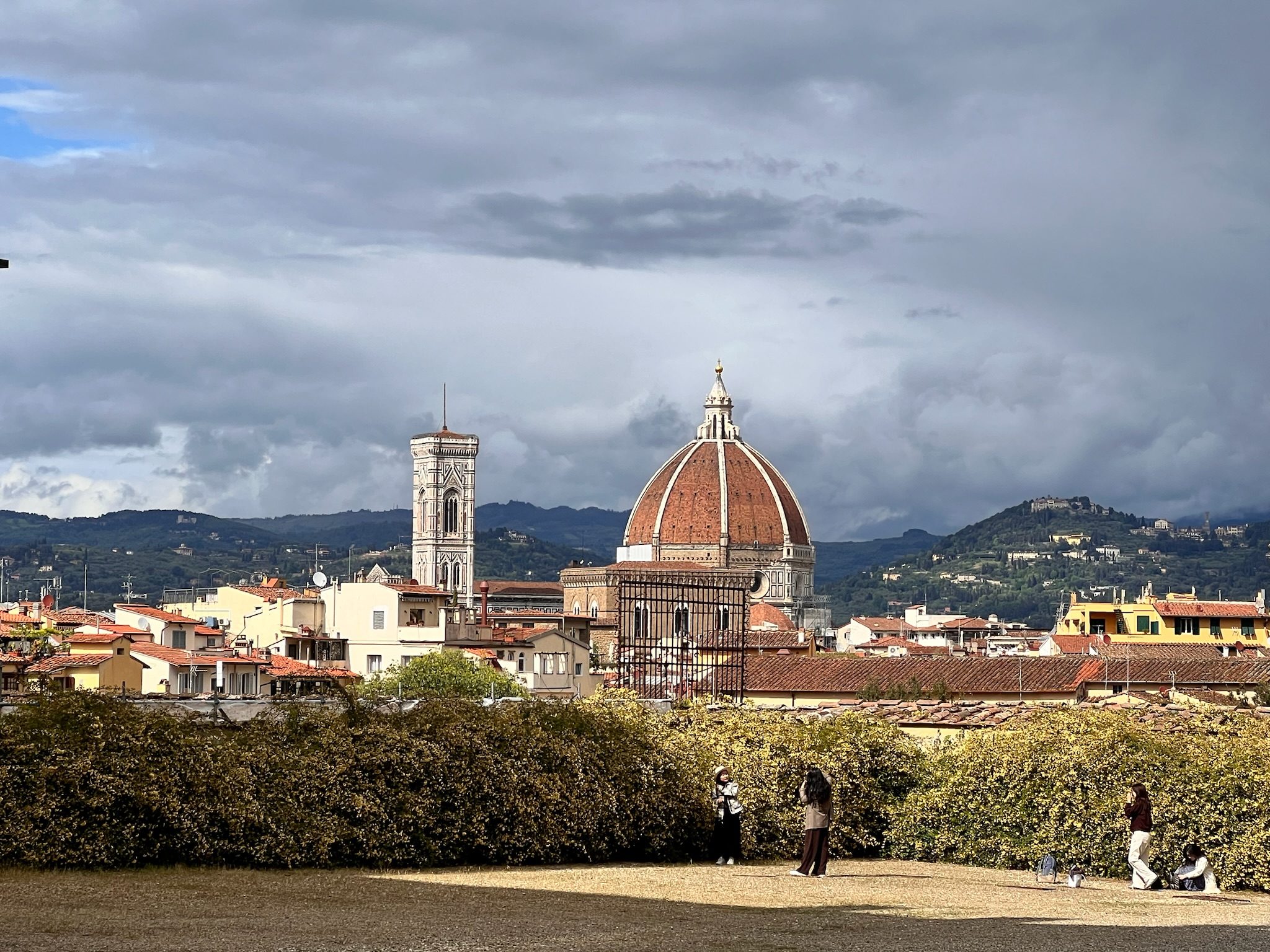 The dome of Florence Cathedral and Giotto's campanile above the city, with the Tuscan hills beyond